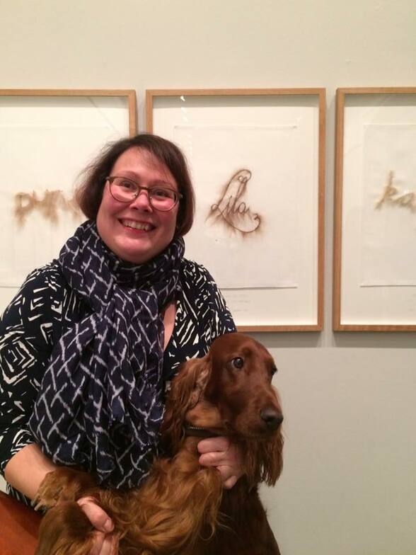 Irish red setter Lila in an art exhibition with her owner