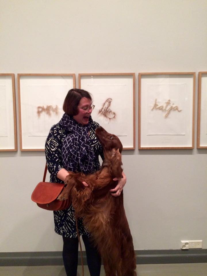 Irish red setter Lila in an art exhibition with her owner